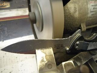pocket knife being sharpened